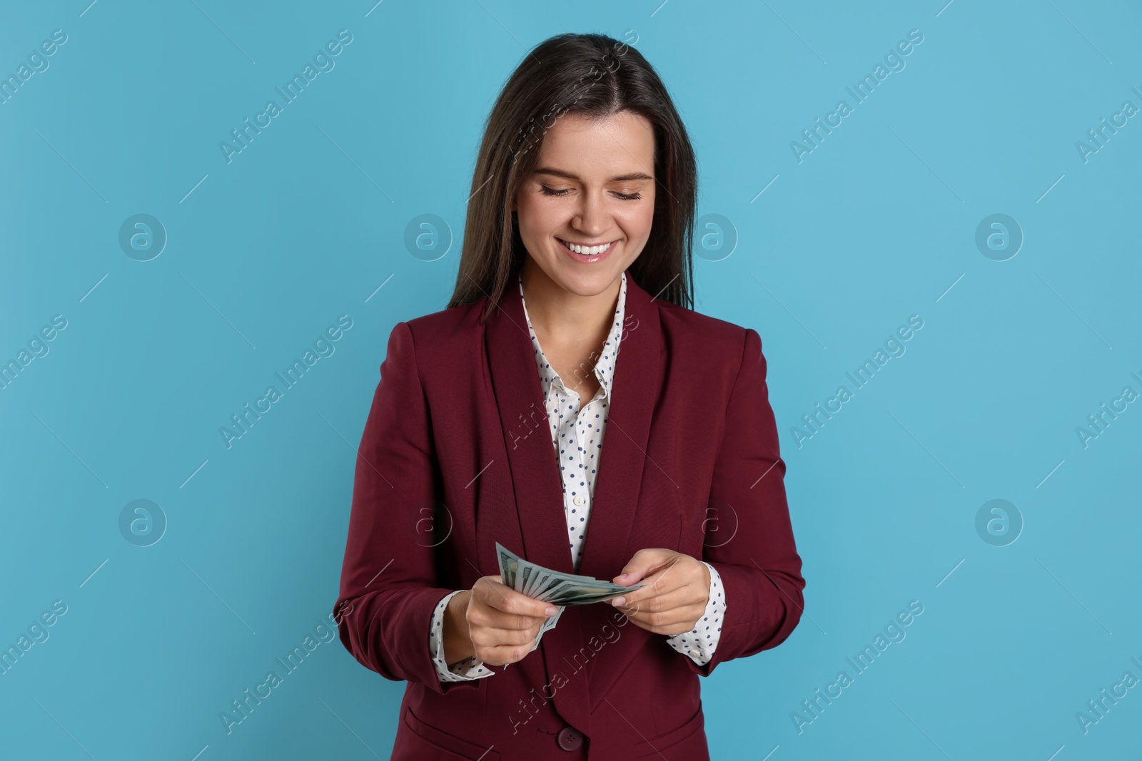 Photo of Banker with dollar banknotes on light blue background