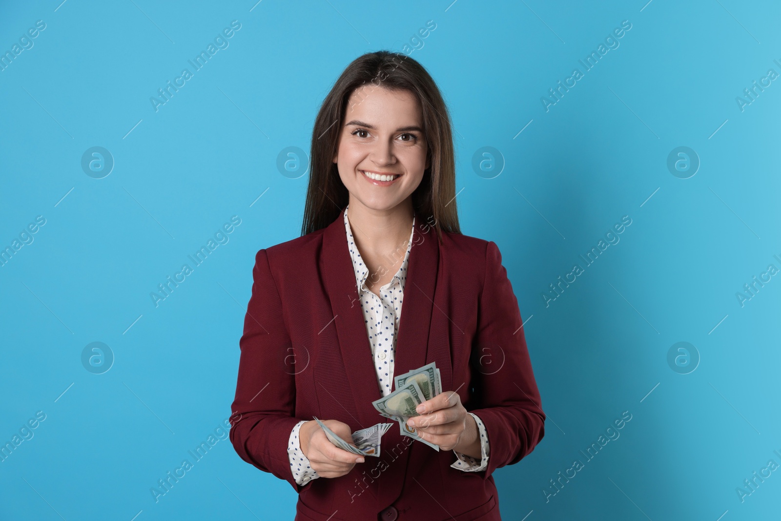 Photo of Banker with dollar banknotes on light blue background