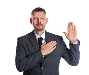 Photo of Man making promise with raised hand on white background. Oath gesture