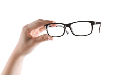 Photo of Woman holding glasses with black plastic frame on white background, closeup