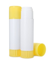 Photo of Two glue sticks with caps isolated on white