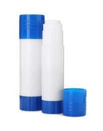 Photo of Two glue sticks with caps isolated on white