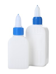 Photo of Bottles of glue with caps isolated on white