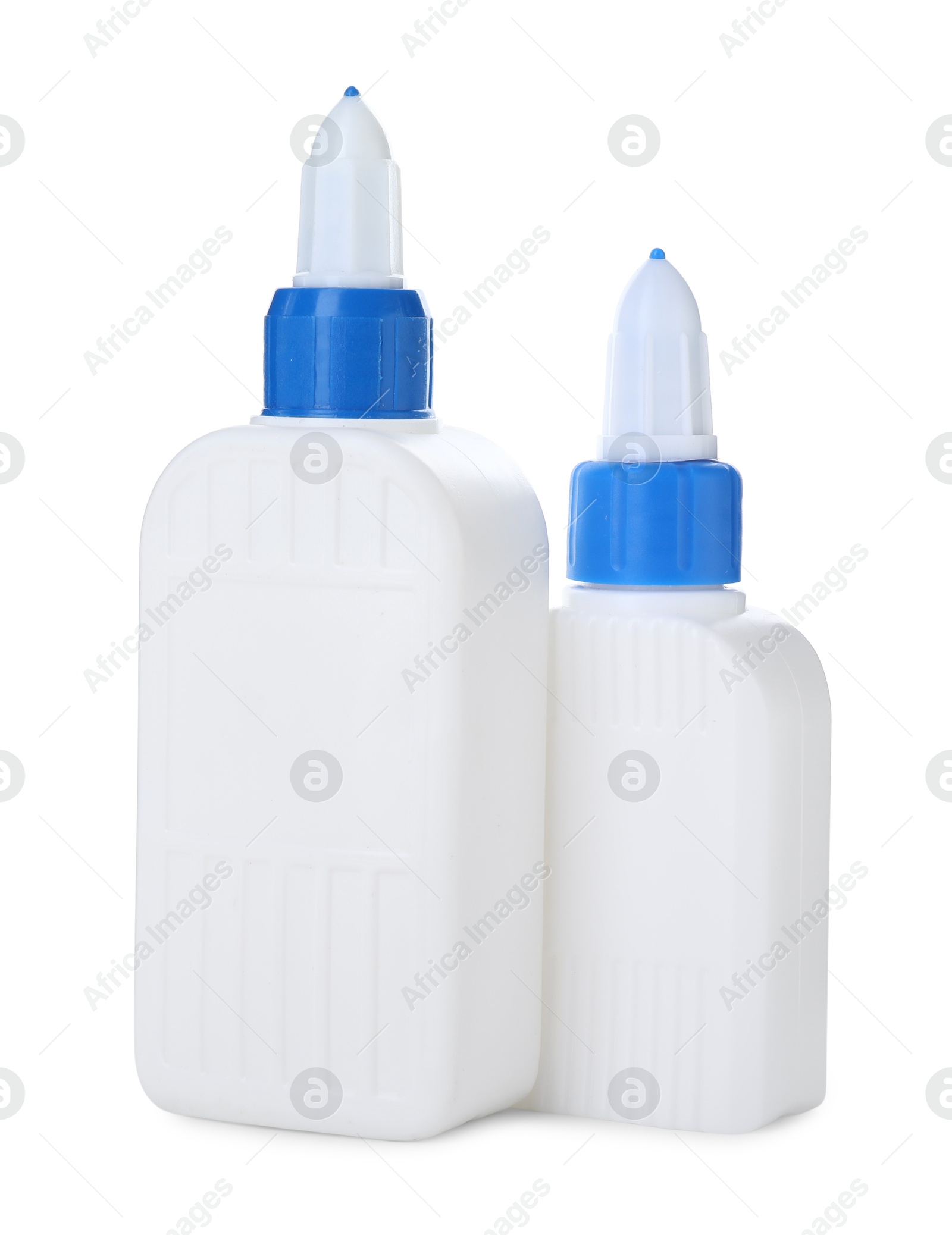 Photo of Bottles of glue with caps isolated on white