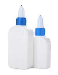 Photo of Bottles of glue with caps isolated on white