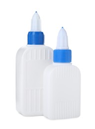 Photo of Bottles of glue with caps isolated on white