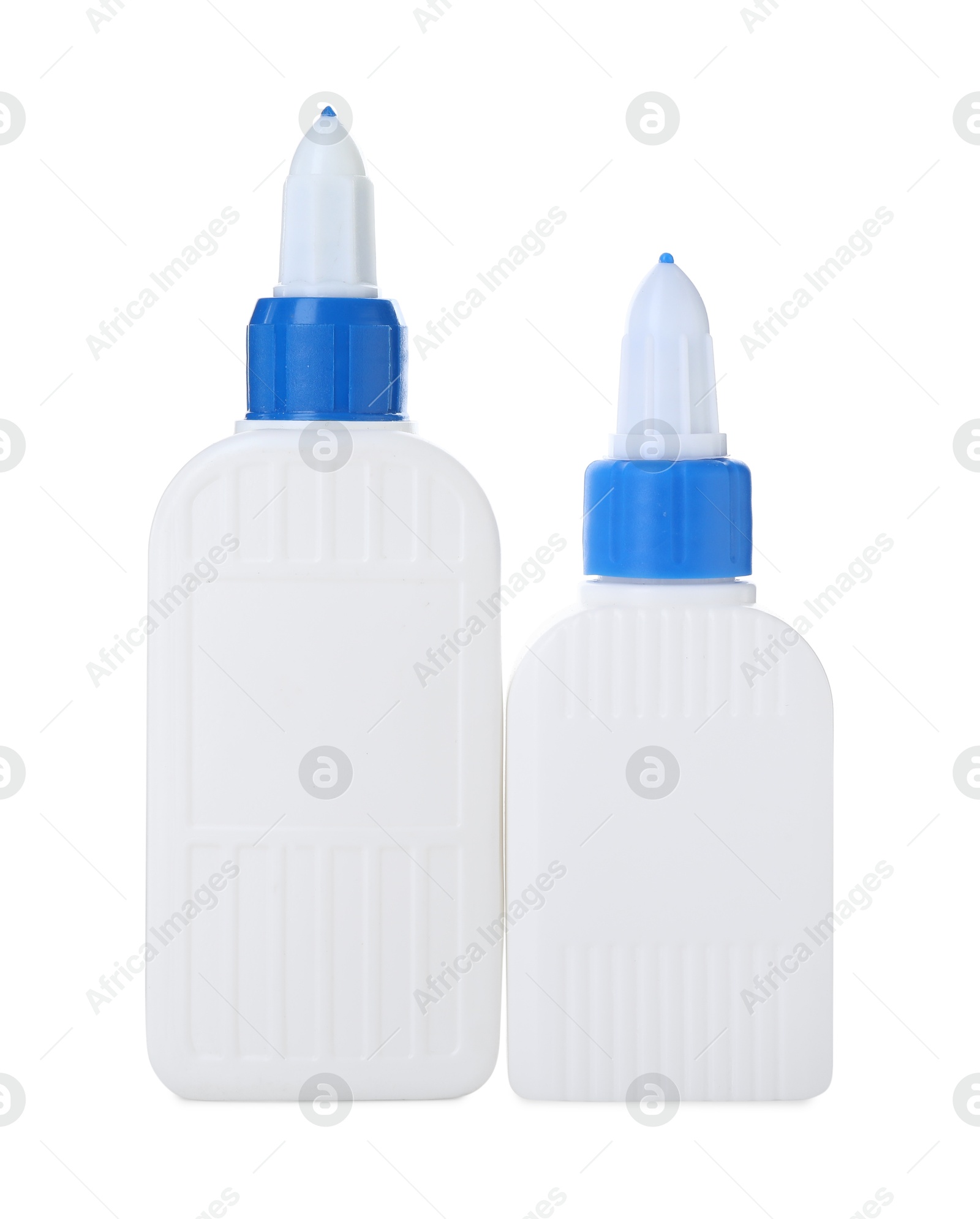 Photo of Bottles of glue with caps isolated on white