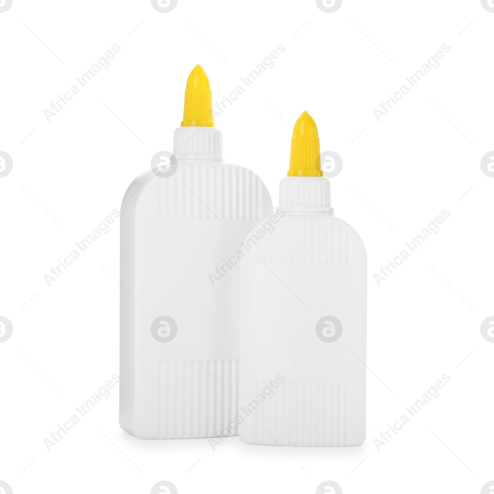 Photo of Bottles of glue with caps isolated on white