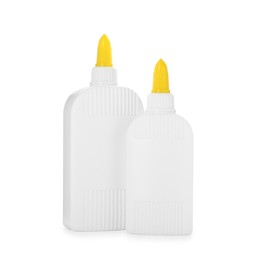 Photo of Bottles of glue with caps isolated on white