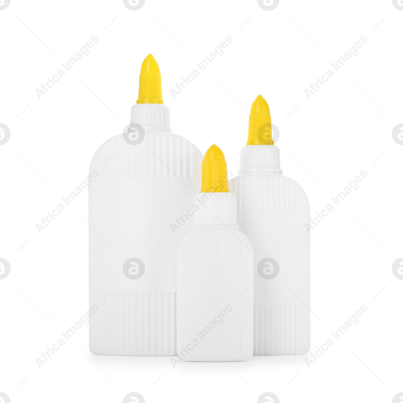 Photo of Bottles of glue with caps isolated on white