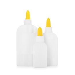 Photo of Bottles of glue with caps isolated on white