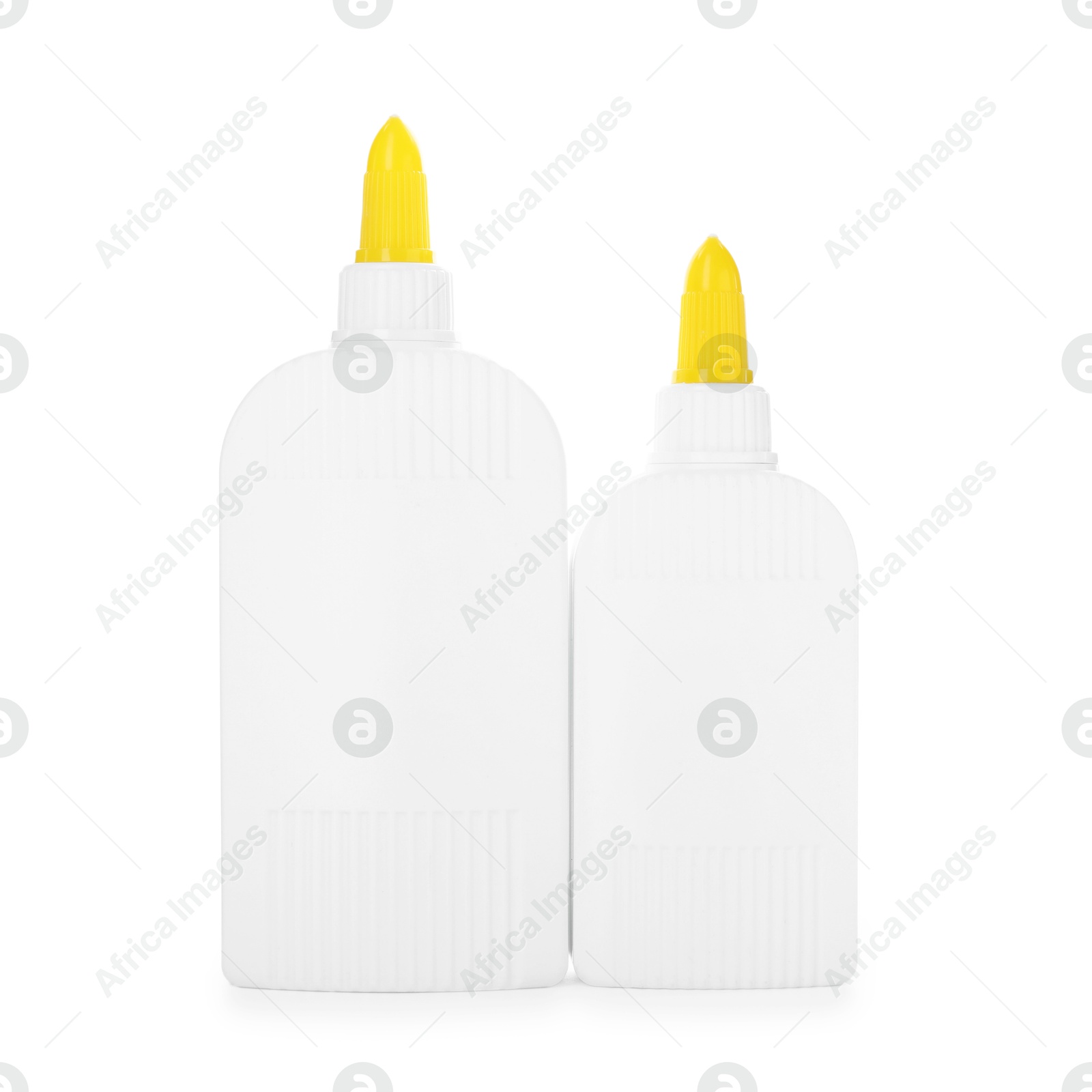 Photo of Bottles of glue with caps isolated on white