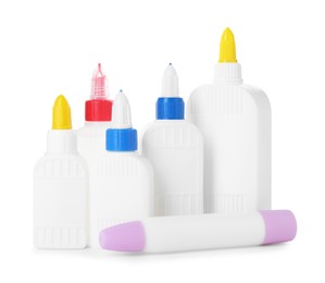 Photo of Bottles and sticks of glue on white background