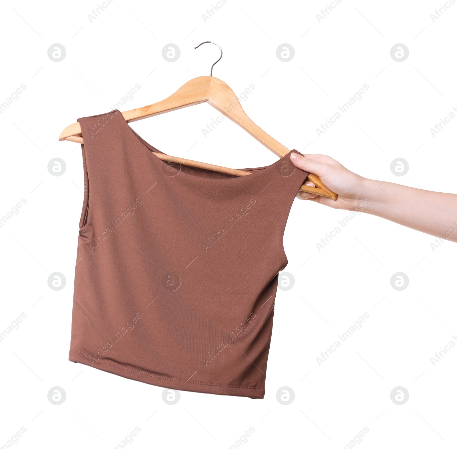 Photo of Woman holding hanger with brown tank top on white background, closeup