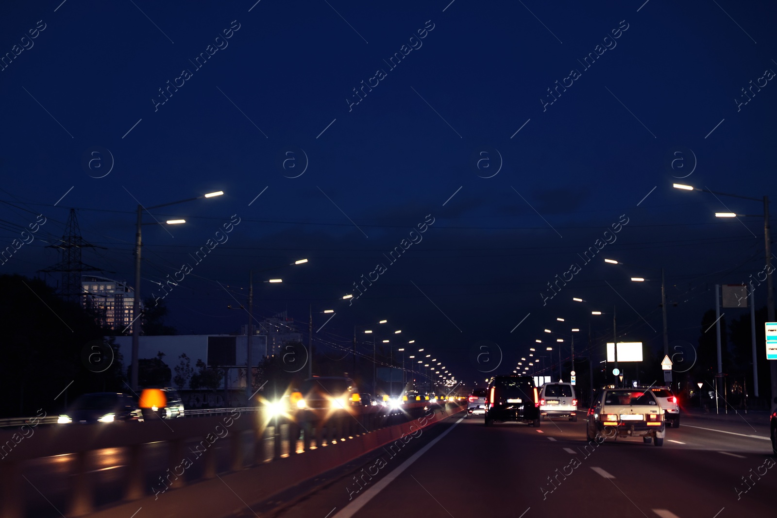 Photo of Cityscape with road traffic and street lights in evening