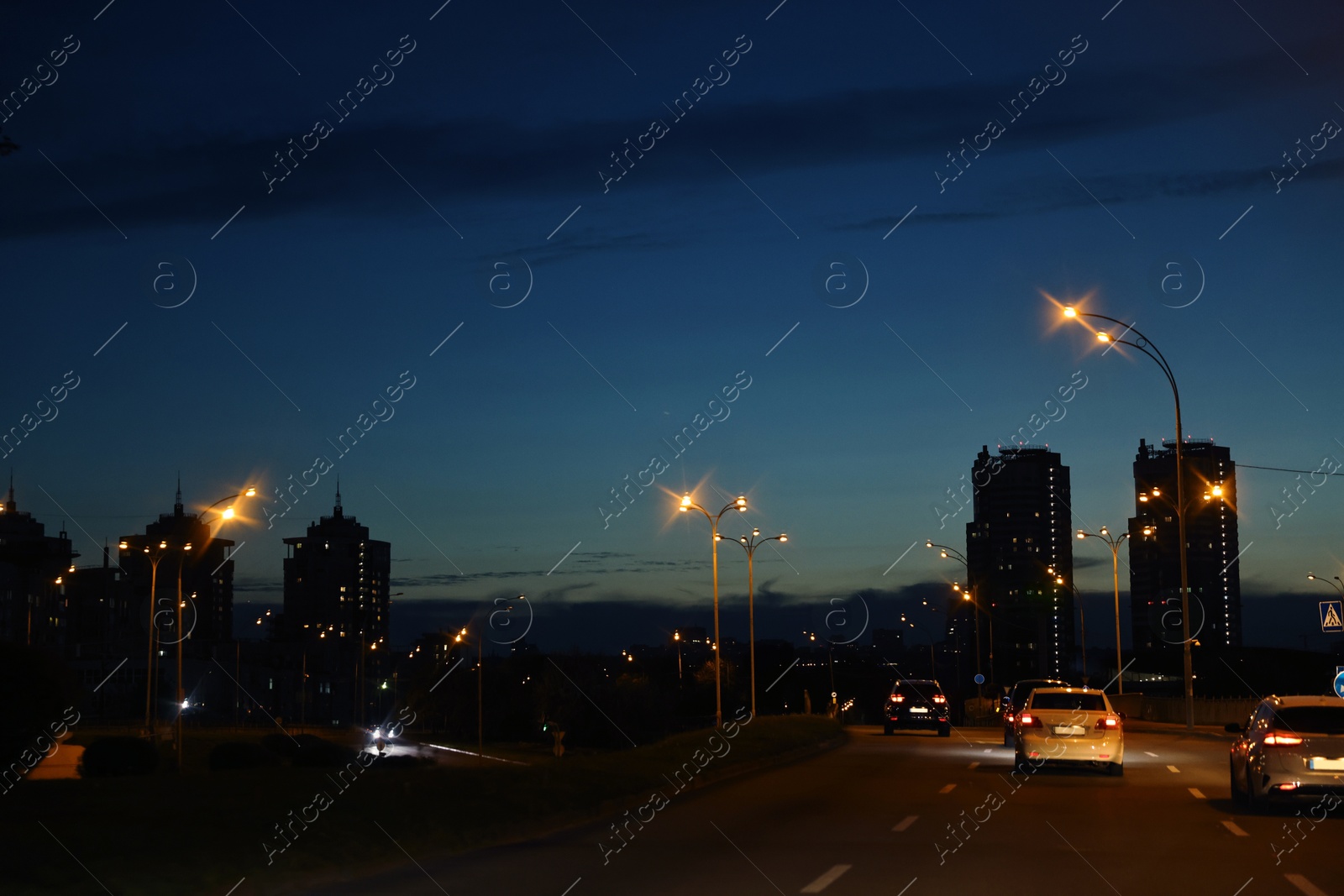 Photo of Cityscape with road traffic and street lights in evening