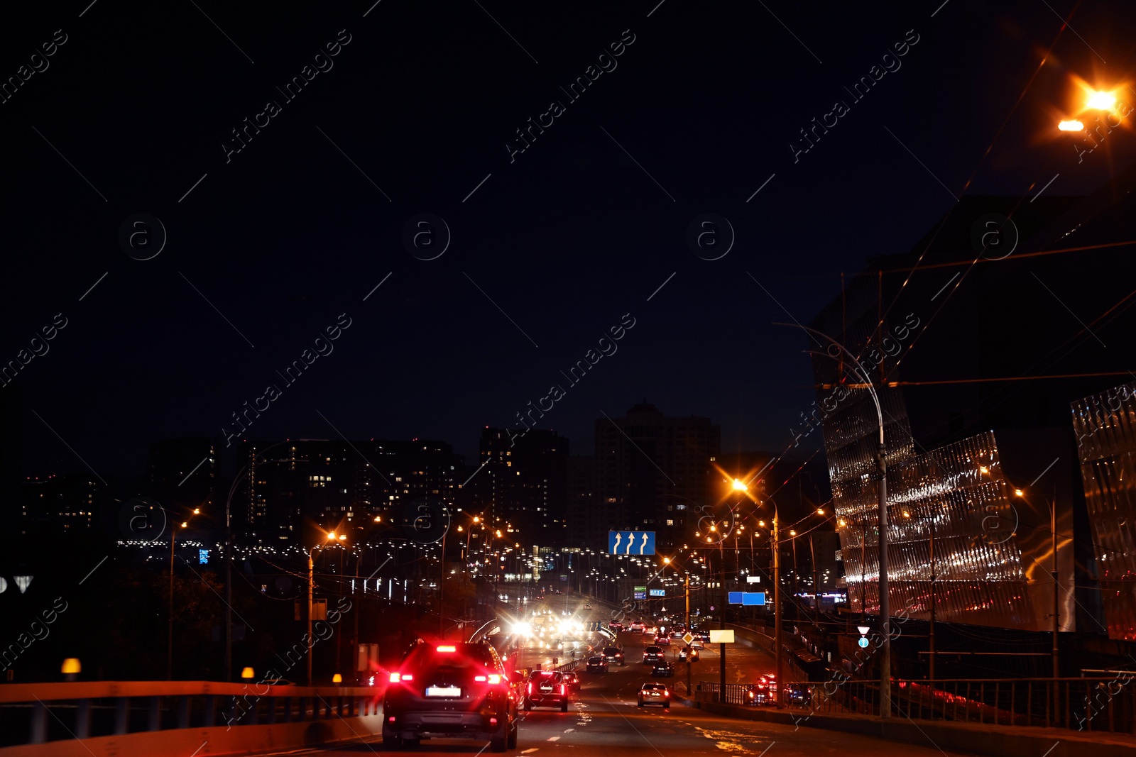 Photo of Cityscape with road traffic and street lights at night