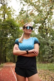 Photo of Portrait of young athletic woman in park