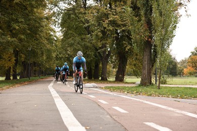 Photo of Group of athletic people riding bicycles outdoors