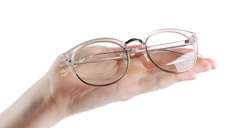 Photo of Woman holding glasses with stylish transparent frame on white background, closeup