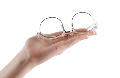 Photo of Woman holding glasses with stylish transparent frame on white background, closeup