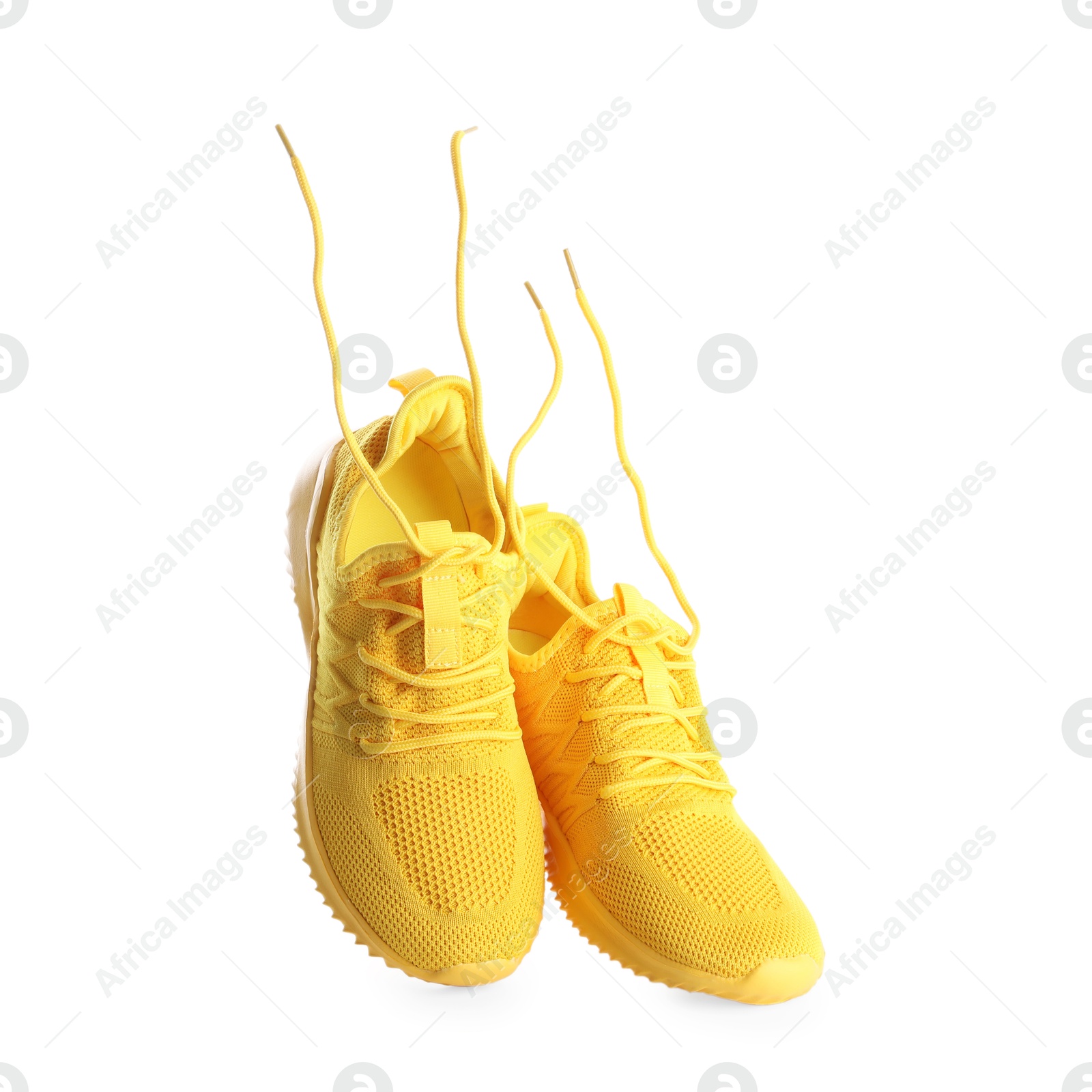 Photo of Pair of stylish yellow sneakers isolated on white