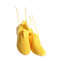 Photo of Pair of stylish yellow sneakers isolated on white