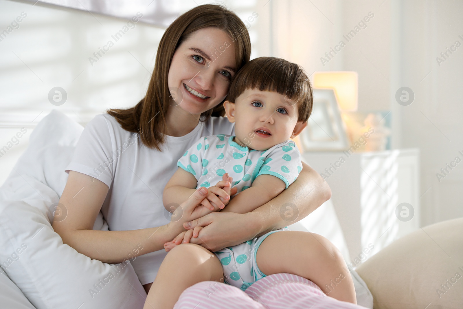 Photo of Family portrait of happy mother with her little son in bedroom