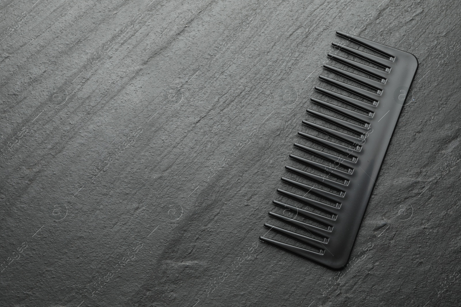 Photo of One plastic hair comb on grey background, top view. Space for text