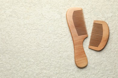 Photo of Different wooden hair combs on beige background, top view. Space for text