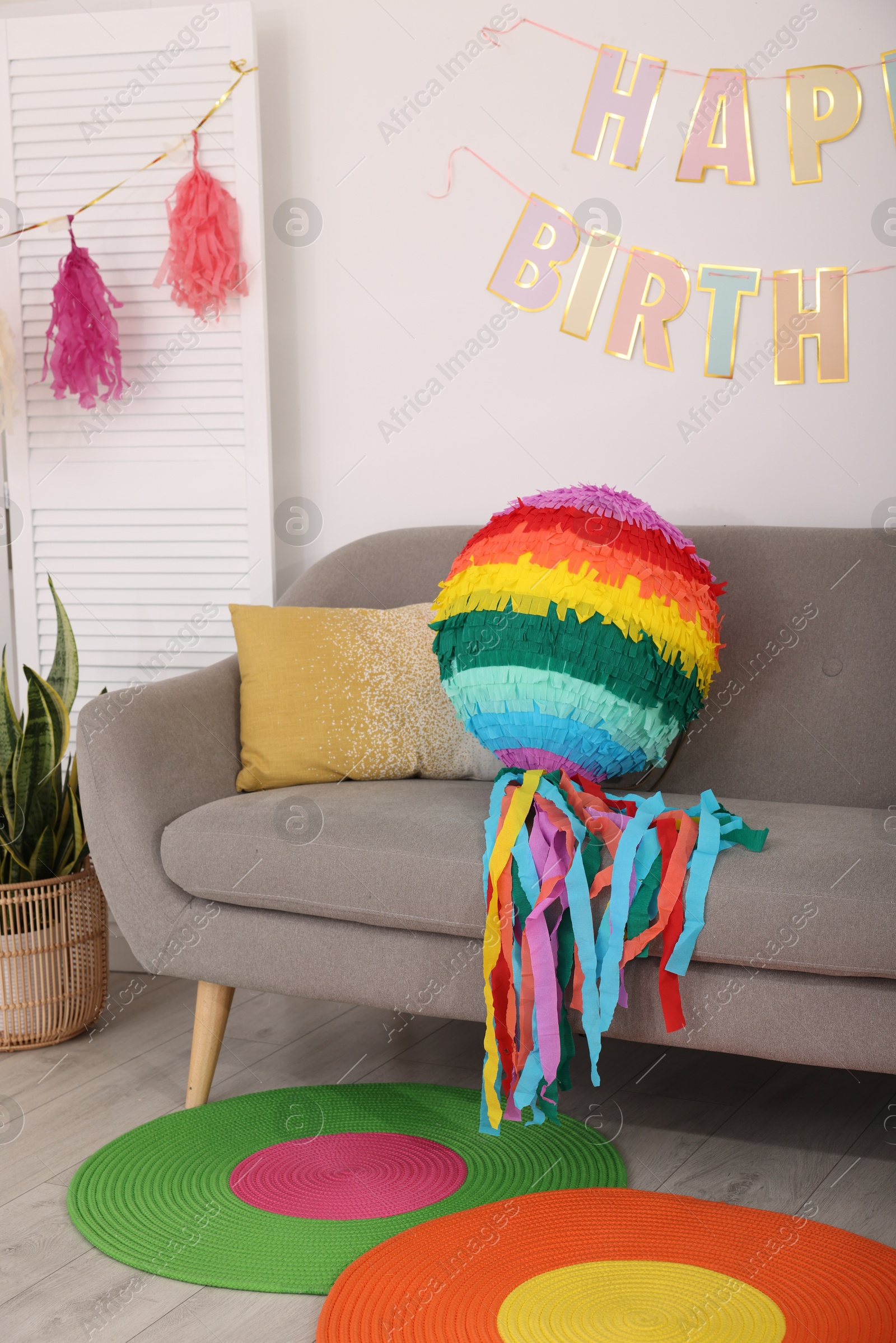 Photo of Colorful pinata and party accessories in festive decorated room