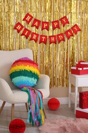 Colorful pinata and party accessories in festive decorated room