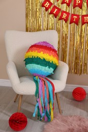 Photo of Colorful pinata and party accessories in festive decorated room