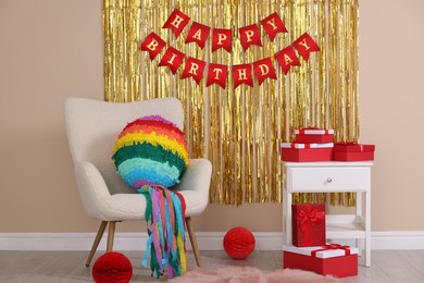 Photo of Colorful pinata and party accessories in festive decorated room