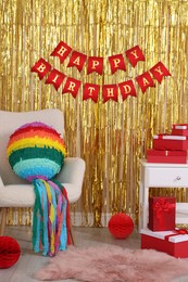 Photo of Colorful pinata and party accessories in festive decorated room