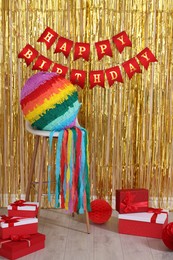 Photo of Colorful pinata and party accessories in festive decorated room