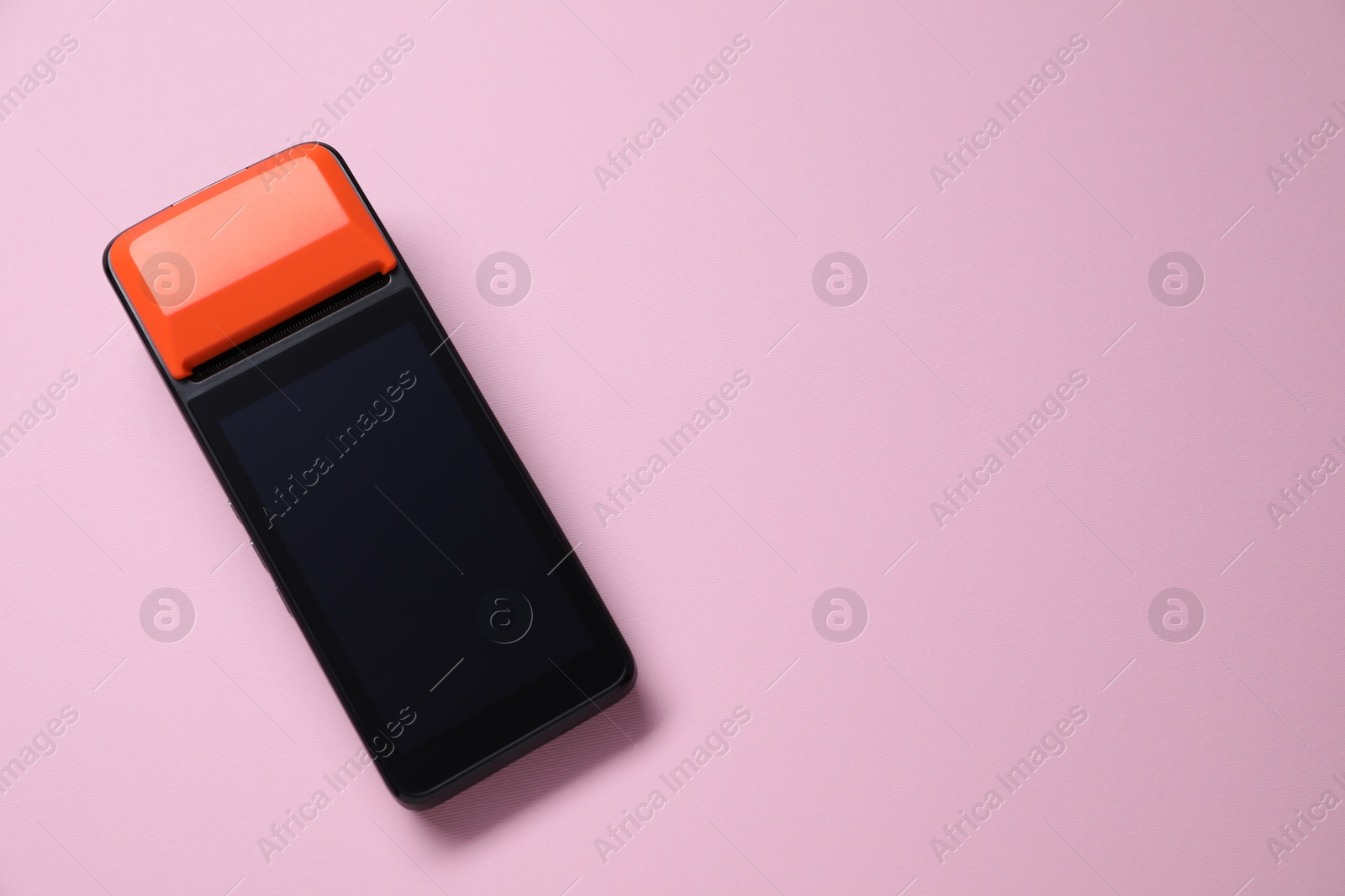 Photo of One payment terminal on pink background, top view. Space for text