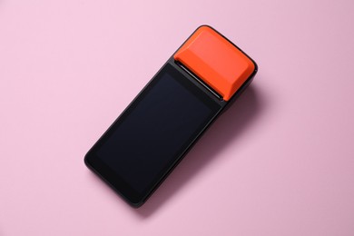 Photo of One payment terminal on pink background, top view