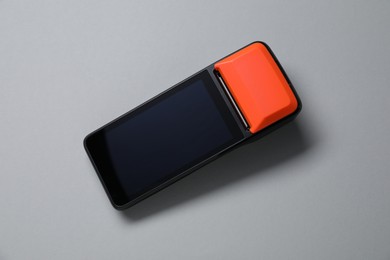 Photo of One payment terminal on grey background, top view