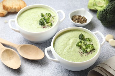 Photo of Delicious broccoli cream soup served on light table