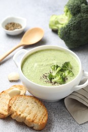 Photo of Delicious broccoli cream soup served on light table