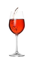 Photo of Tasty wine splashing in glass on white background