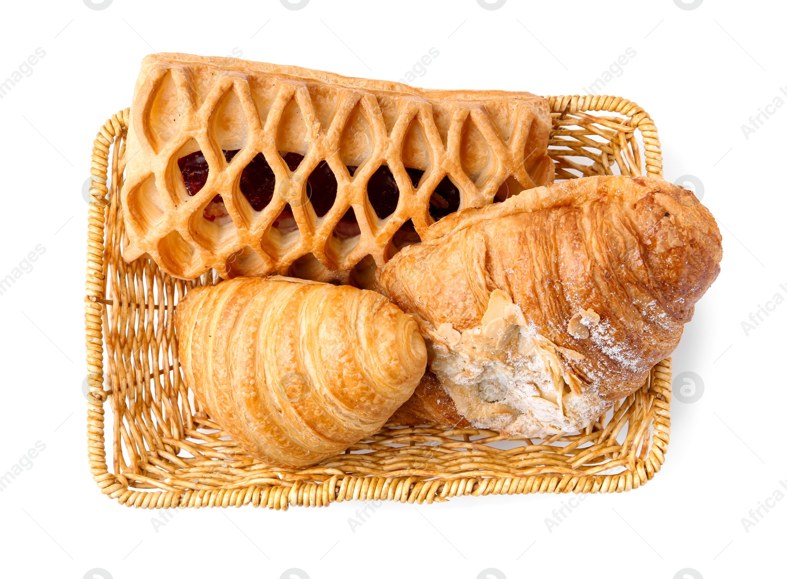 Photo of Different delicious pastries in basket isolated on white, top view