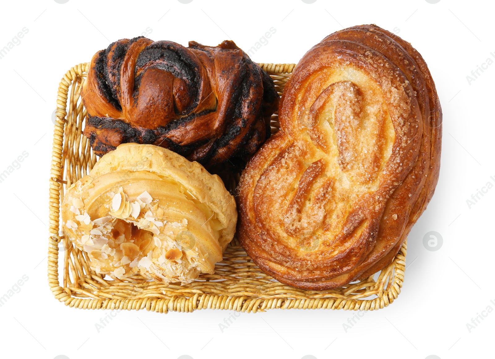 Photo of Different delicious pastries in basket isolated on white, top view