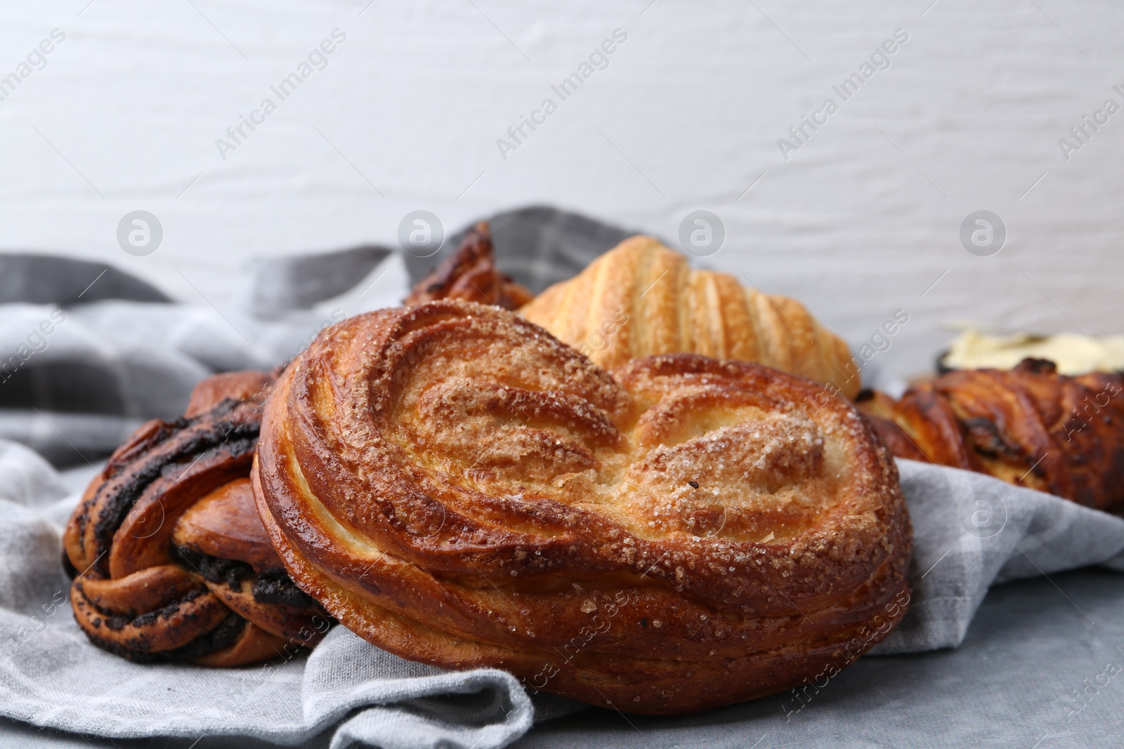 Photo of Different delicious pastries on grey table, closeup