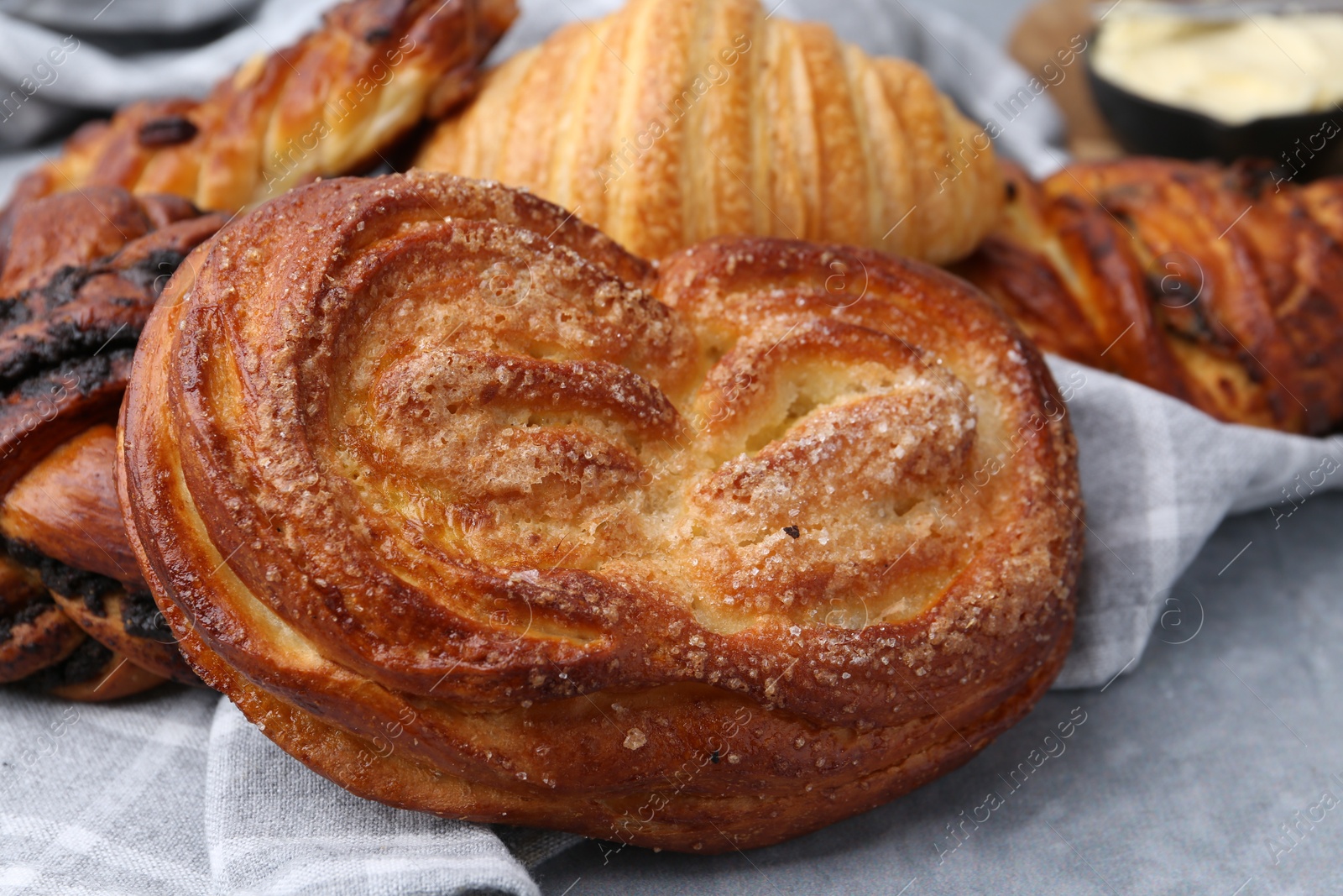 Photo of Different delicious pastries on grey table, closeup