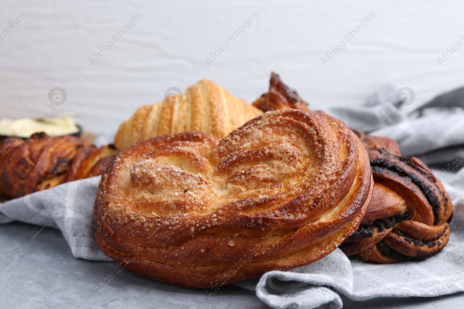 Photo of Different delicious pastries on grey table, closeup