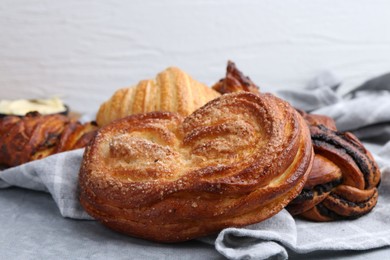 Photo of Different delicious pastries on grey table, closeup