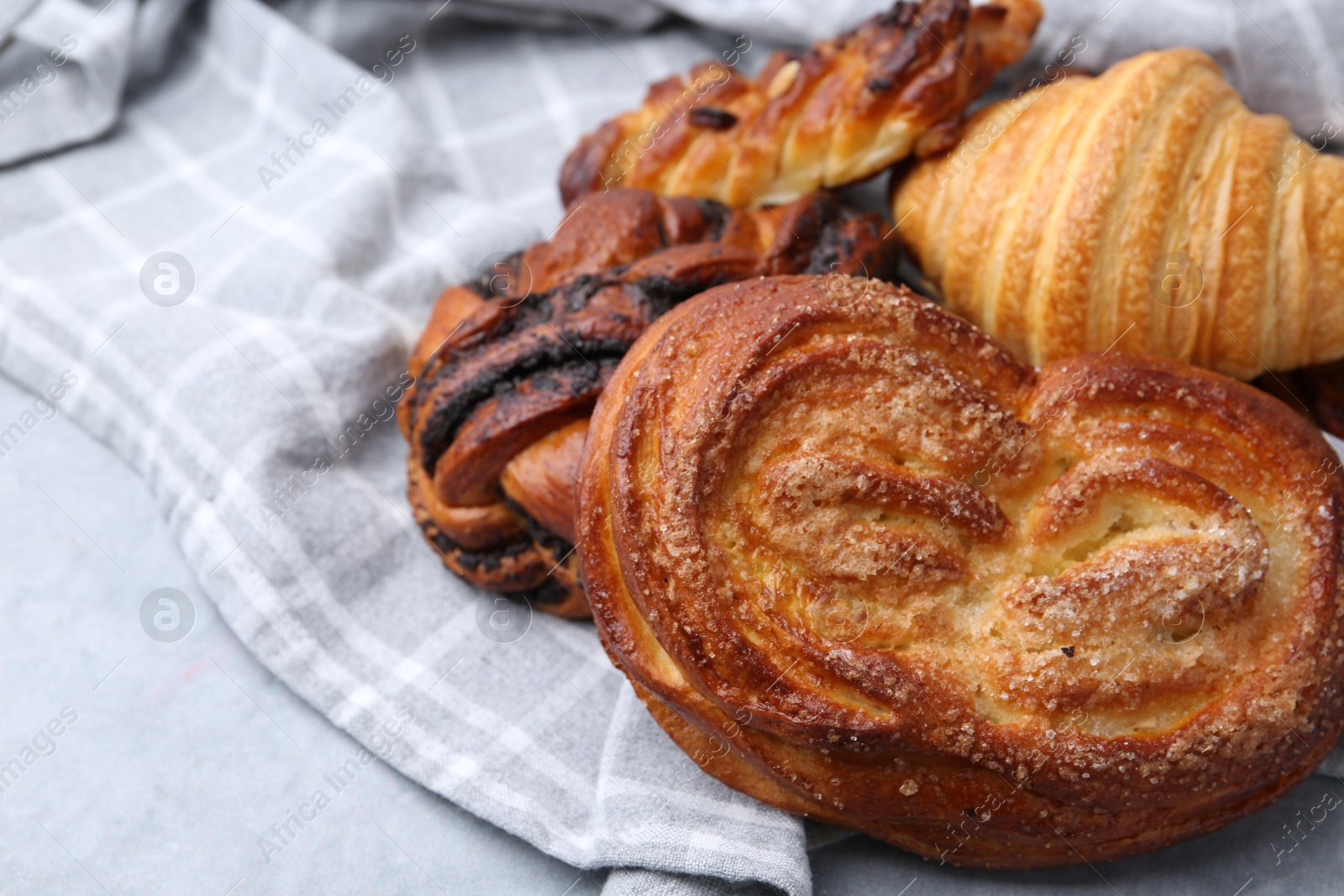 Photo of Different delicious pastries on grey table, closeup