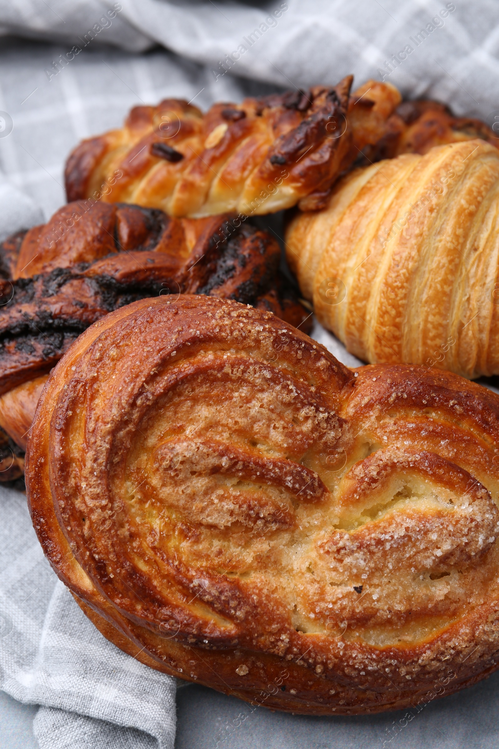 Photo of Different delicious pastries on grey table, closeup